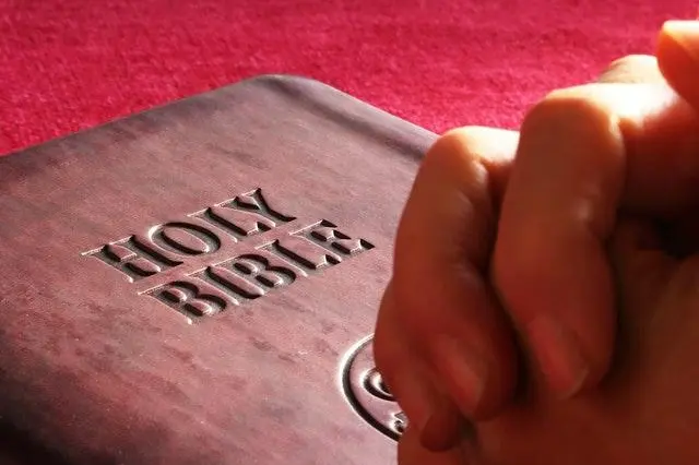 Bible and praying hands