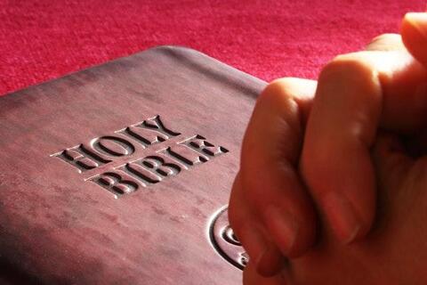 Bible and praying hands Bible and praying hands